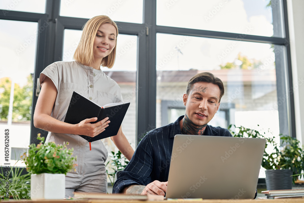 A team of young coworkers engages in a creative discussion, surrounded by plants and modern decor. A team of young coworkers engages in a creative discussion, surrounded by plants and modern decor.