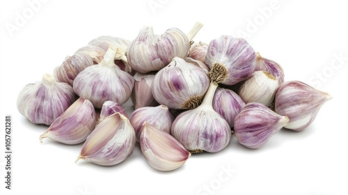 Close up view of fresh organic garlic cloves and bulbs for culinary use presented against a white background