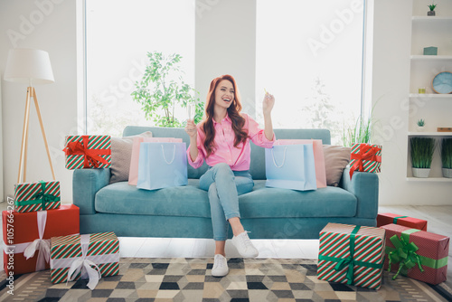 Full size photo of attractive redhair woman enjoy celebrate birthday sit couch dressed pink outfit cozy day light home interior living room