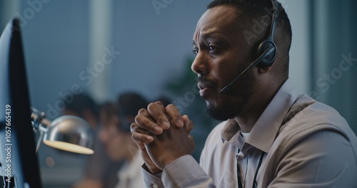 Fotografi Call center office of emotional support line: Portrait of African American hotline specialist in headset consulting person on call, providing psychological help