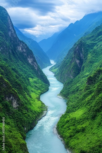 A breathtaking view of a winding river surrounded by lush green mountains.