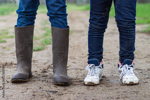Photography two kids legs standing in the mud