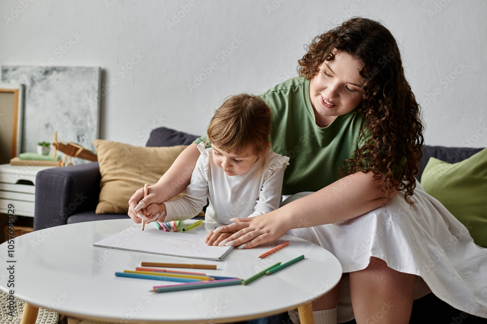 Fototapeta premium A mother and her young daughter share a creative moment, coloring and bonding at home.
