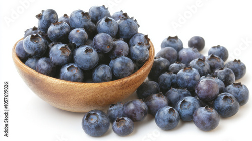 small bowl of blueberries spilling slightly over edge, on white background