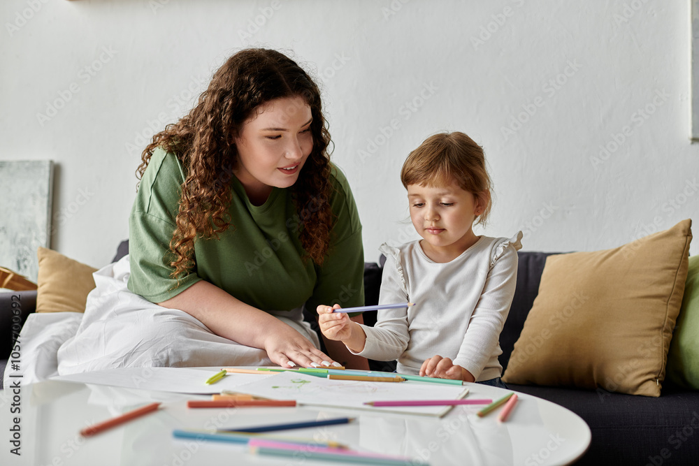A plus size mother and her daughter share a creative moment, enjoying coloring together. A plus size mother and her daughter share a creative moment, enjoying coloring together.