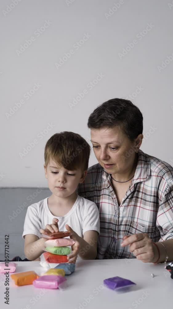 Mother and child playing with colorful clay together at table Mother and child playing with colorful clay together at table