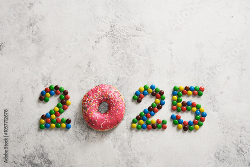 Candy and donut figures 2025 on a light background. Concept of the new year.
