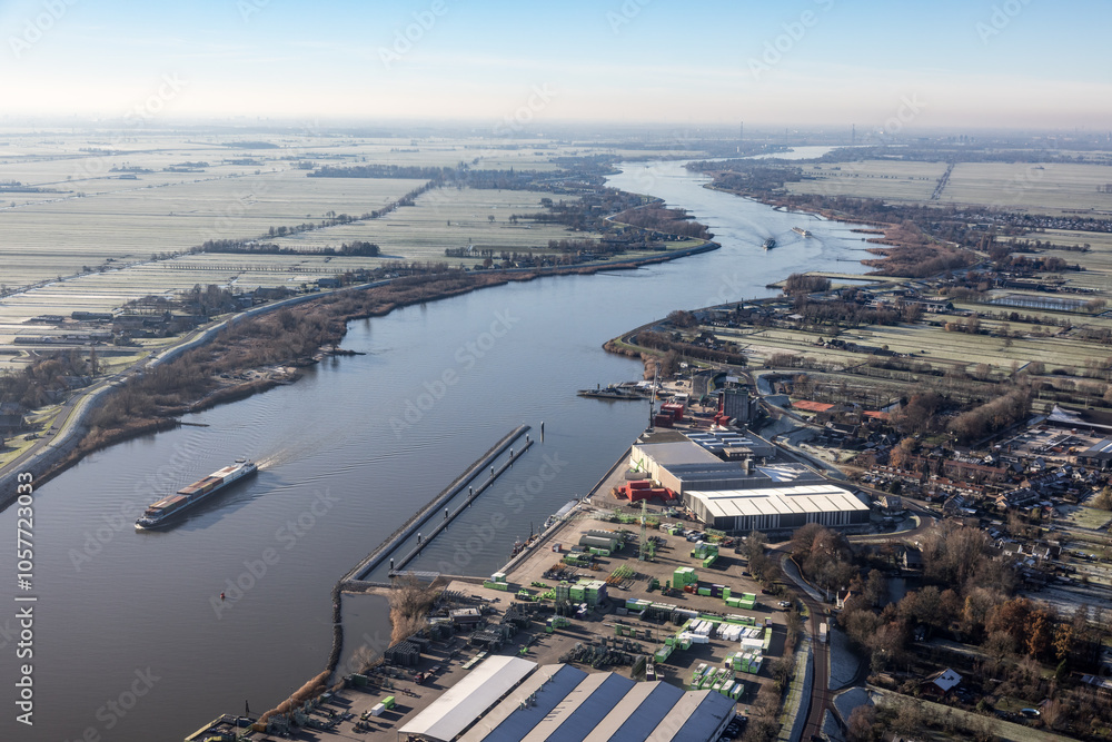Fototapeta premium Aerial view Dutch river Lek with view at village Bergambacht