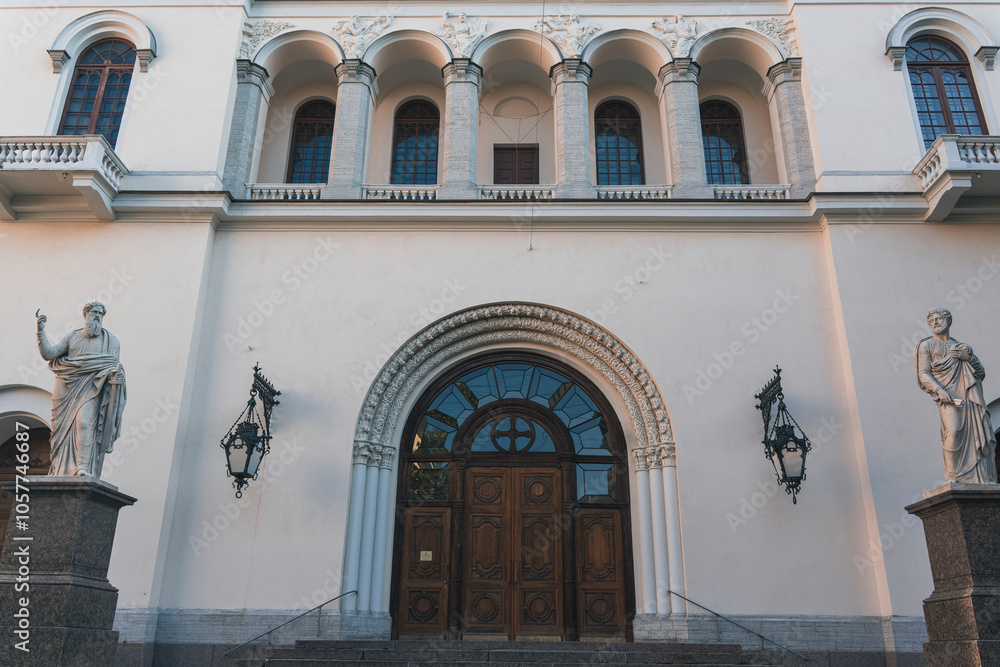 Ornate entrance with statues and arched doorway on historic building Ornate entrance with statues and arched doorway on historic building