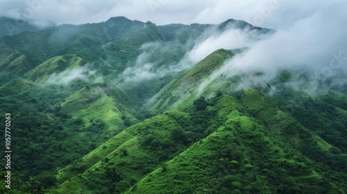 Lush green mountainsides with misty clouds overhead