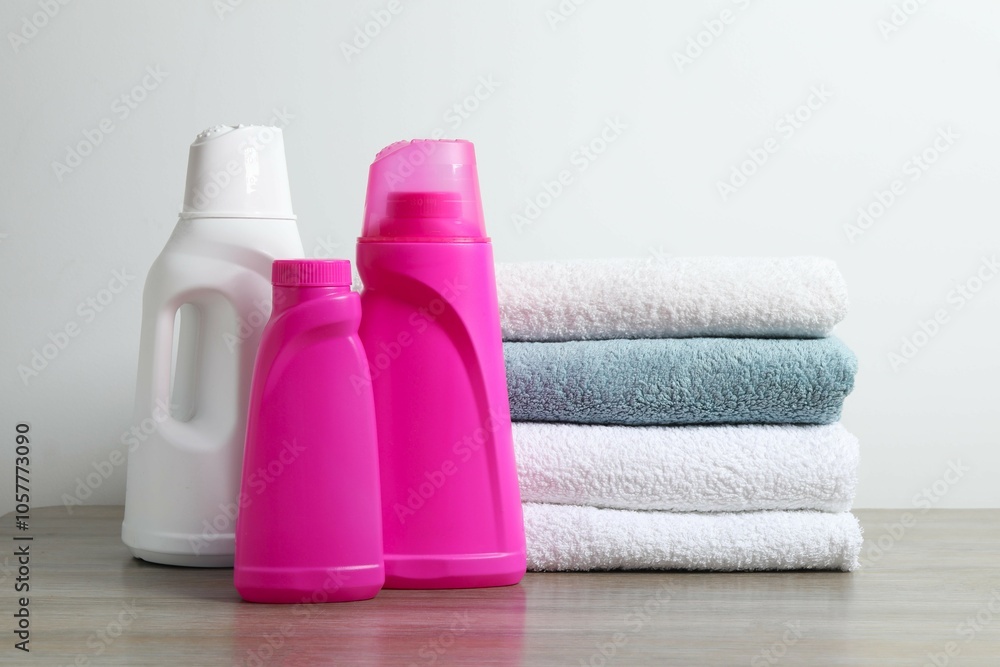 A stack of freshly washed towels and washing products on the table A stack of freshly washed towels and washing products on the table