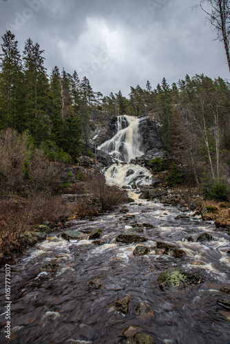 Landscape shot of a large waterfall in the forest and nature. Autumn landscape The Elgafossen Vattenfall river provides a natural border between Sweden and Norway at Vassbotten, Scandinavia photo