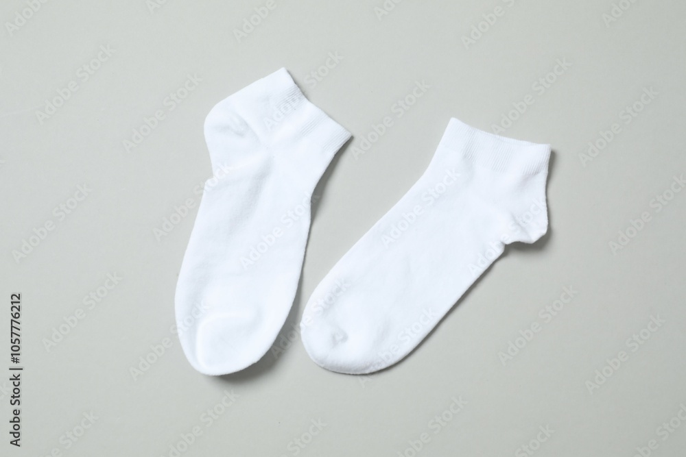 White socks on gray background, flat lay. White socks on gray background, flat lay.