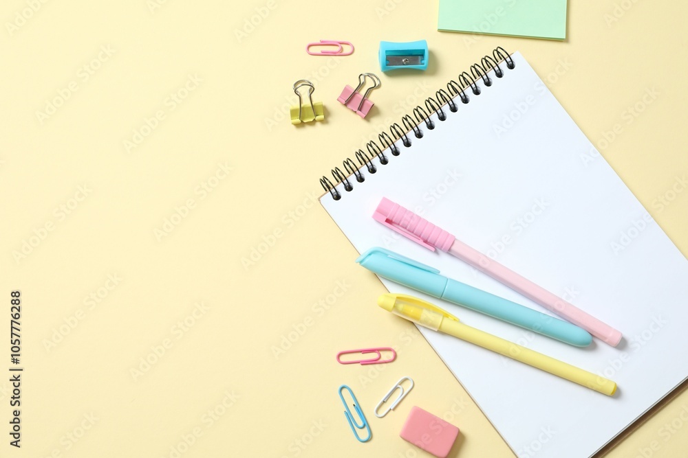 Flat lay with colorful school stationery and notebook on color background, top view Flat lay with colorful school stationery and notebook on color background, top view