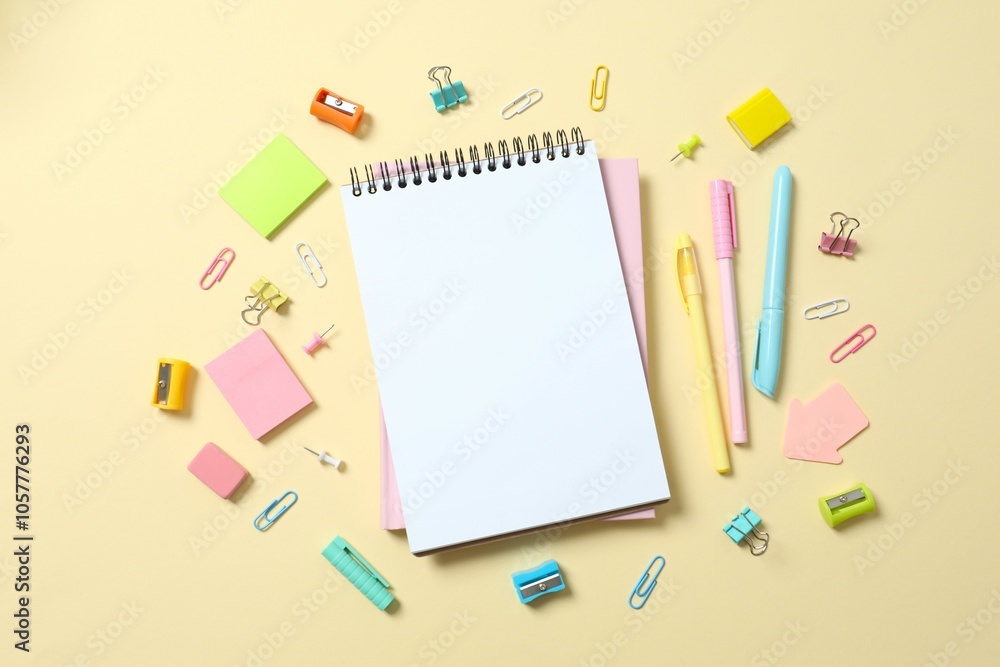 Flat lay with colorful school stationery and notebook on color background, top view Flat lay with colorful school stationery and notebook on color background, top view