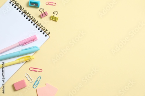 Flat lay with colorful school stationery and notebook on color background, top view