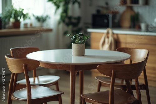 Round dining table with wooden chairs in a bright, modern interior