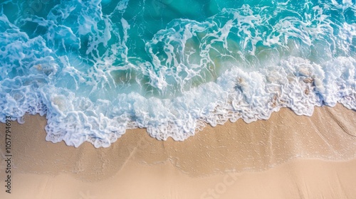 Turquoise ocean waves meeting sandy shore