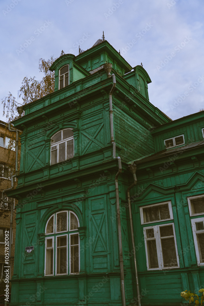 A green, wooden, old building of unusual shape A green, wooden, old building of unusual shape