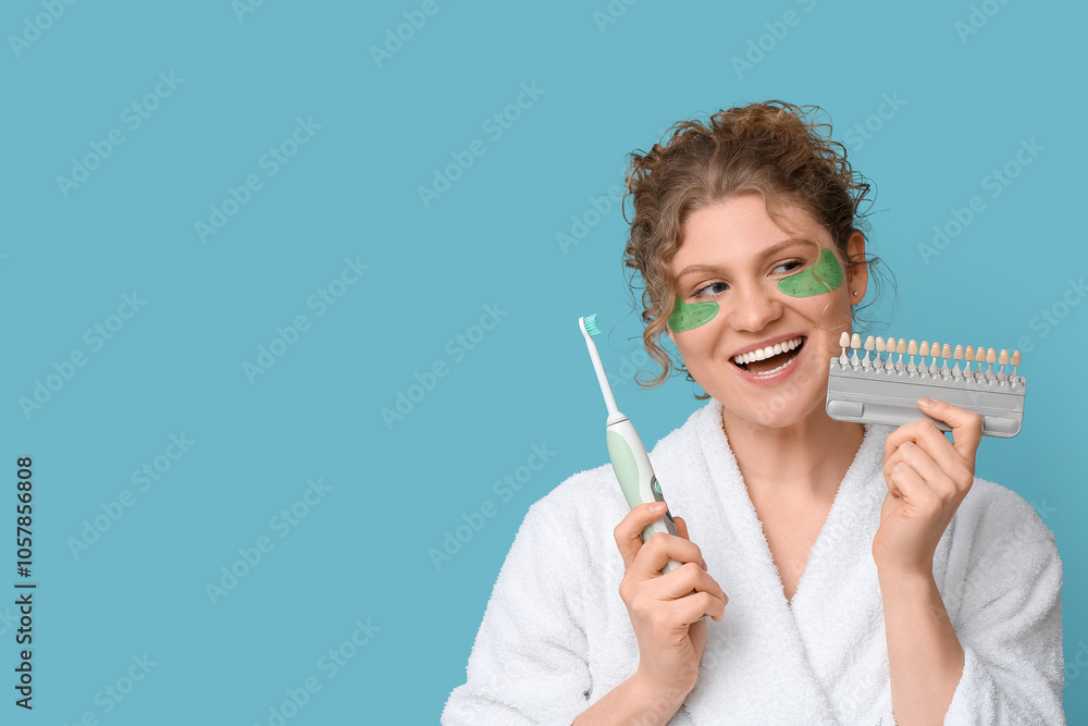 Beautiful young happy woman with eye patches, electric toothbrush and teeth color samples on blue background Beautiful young happy woman with eye patches, electric toothbrush and teeth color samples on blue background