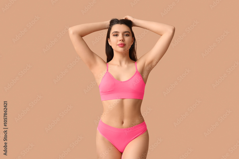 Obraz premium Attractive young woman in sexy lingerie on color background