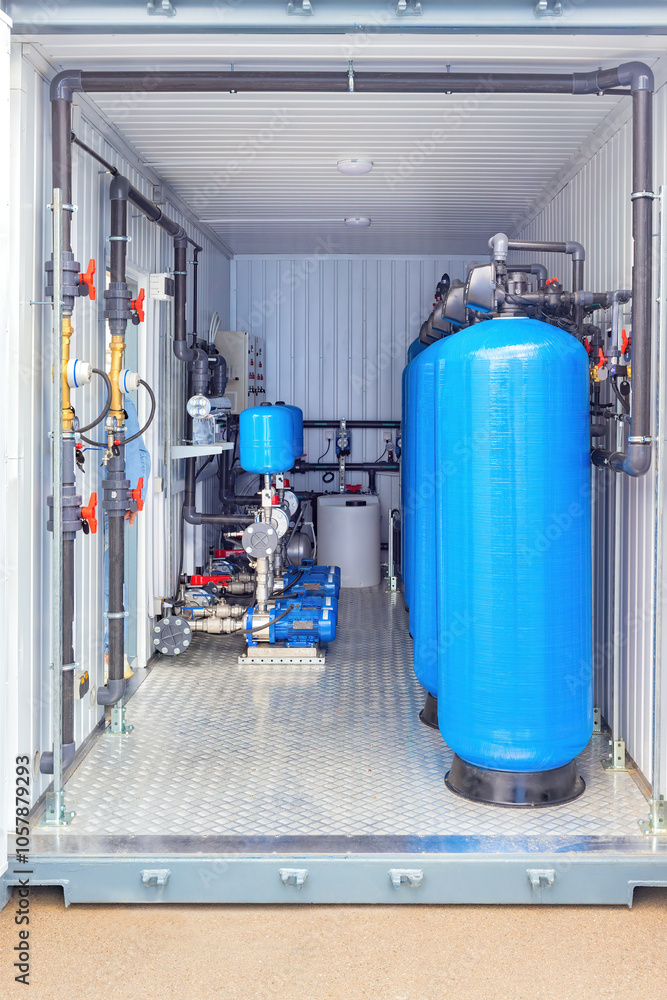 Industrial water filtration system inside container with blue tanks, pipes, machinery, valves, clean water solution