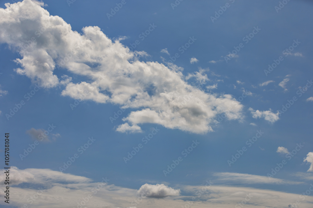 Serene sky with fluffy white clouds on bright sunny day, peaceful nature backdrop, cloudscape tranquility concept