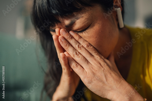 Asian woman stressed and overwhelmed, taking a break from work