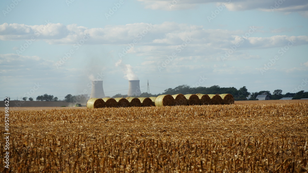 Fototapeta premium Farm Harvest With Power Plant Smoke Stacks In Background