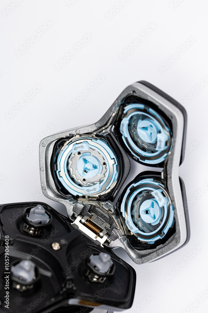 Beard electric shaver on a white background. Inside view of the cutting blades . Photo taken in artificial light with clearly visible details of the shaver