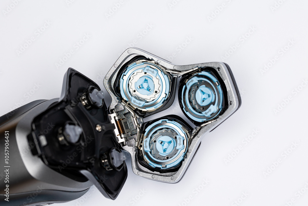 Beard electric shaver on a white background. Inside view of the cutting blades . Photo taken in artificial light with clearly visible details of the shaver