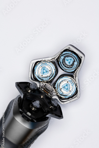 Beard  electric shaver on a white background. Inside view of the cutting blades . Photo taken in artificial light with clearly visible details of the shaver