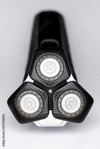 Obraz na płótnie Beard electric shaver on a white background. Close-up of the cutting blades. Photo taken in artificial light with clearly visible details of the shaver w salonie