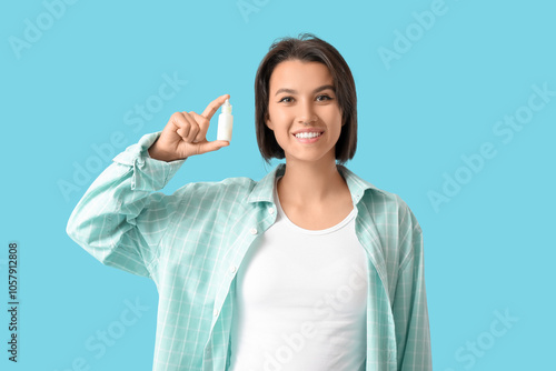 Young woman with eye drops ...