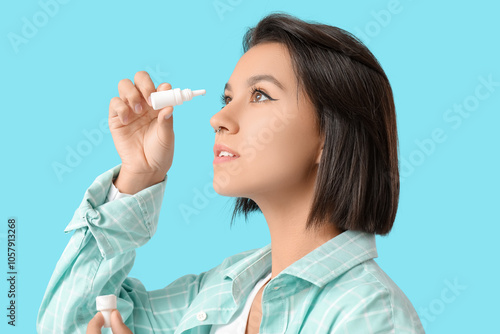 Young woman using eye drops...