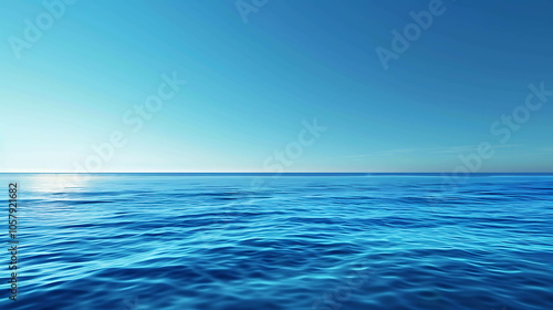 Deep blue ocean. The surface of the water is calm and still. The sky is clear and blue. The horizon is distant and meets the water in a perfect line.