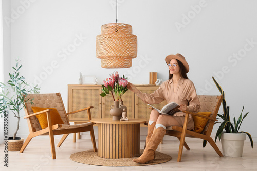 Young woman sitting in armc...