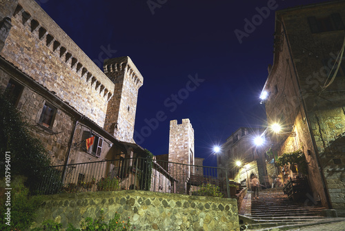 medieval bridge, gate and stone towers in Bolsena at night,