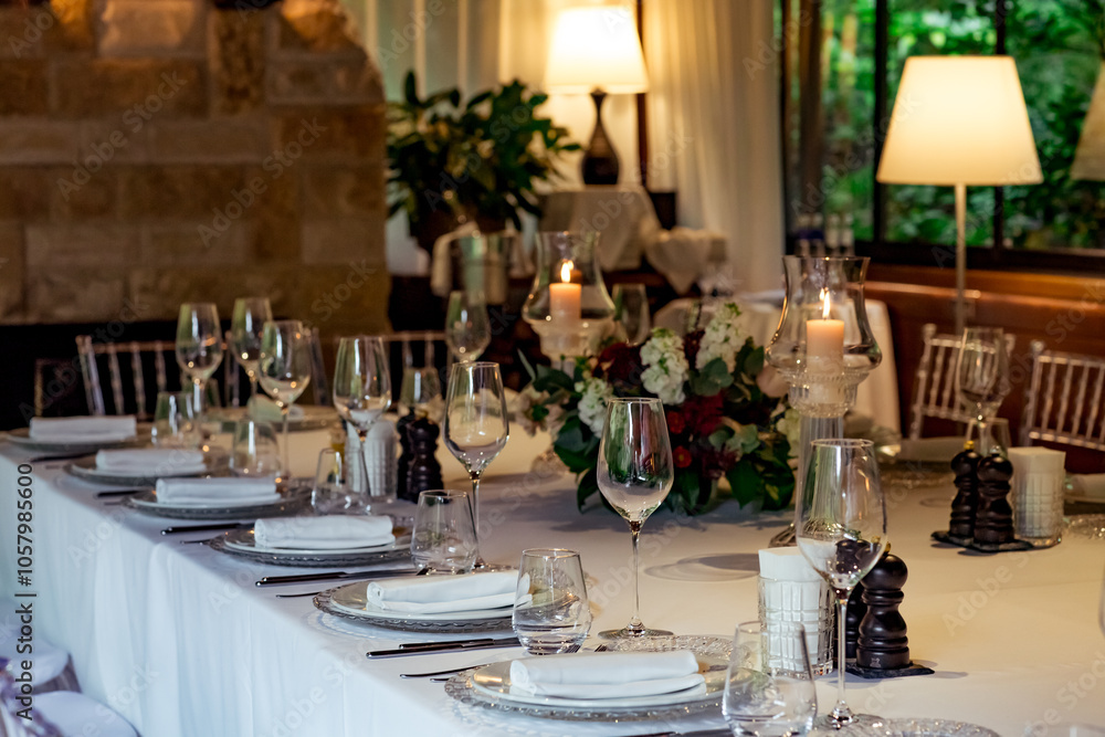 Beautiful table setting, for a holiday. with the dishes .flowers and candles Beautiful table setting, for a holiday. with the dishes .flowers and candles