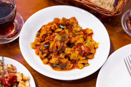 Traditional turkish food Saksuka tarifi with eggplant, tomatoes and olive oil photo