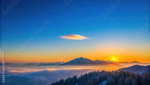 Minimalist sunrise in the mountains with a single cloud on blue sky, capturing a cold winter moment