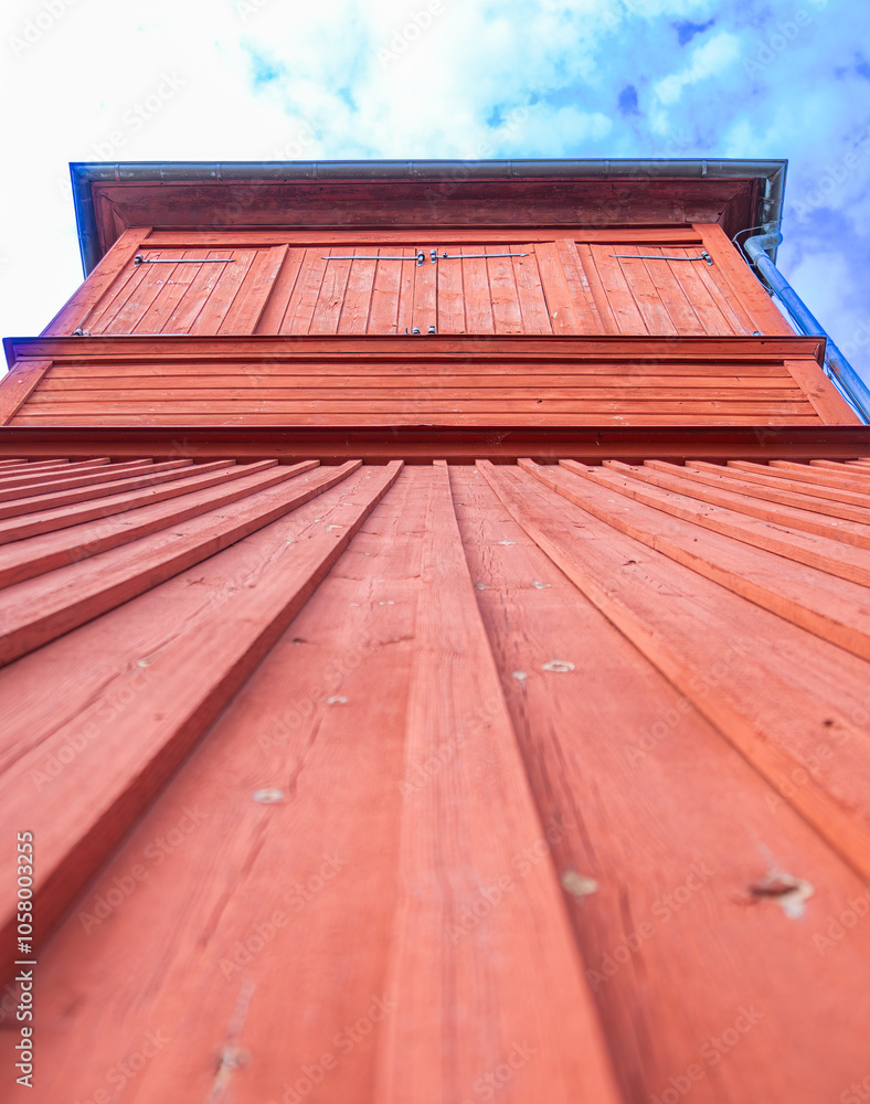 Fototapeta premium Reddish-brown wooden water tower in Stockholm archipelago