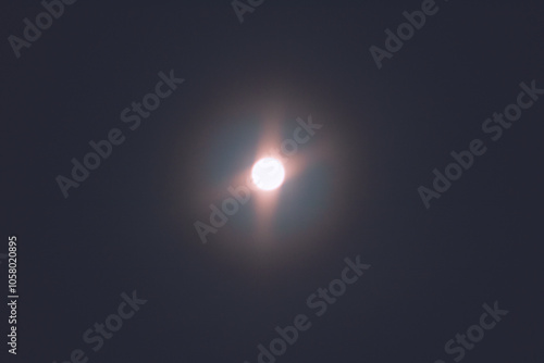 Full moon in the night sky sends amazing glowing light into the night sky. Full moon background texture. Macro.