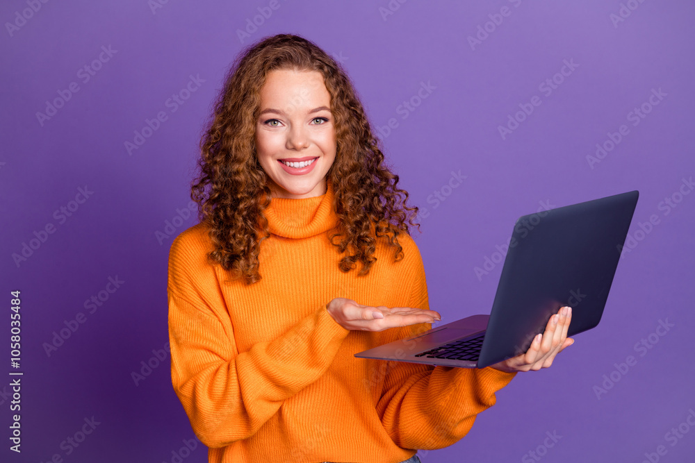 Naklejka premium Photo of nice young girl show laptop wear pullover isolated on violet color background