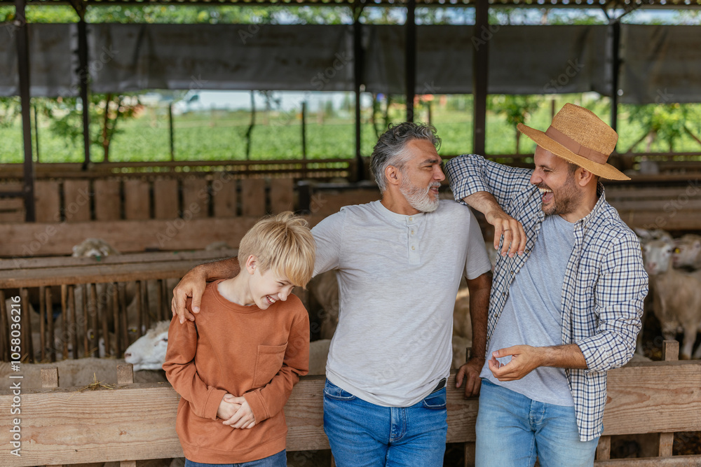 Grandpa telling jokes to his son and his grandson on a farm Grandpa telling jokes to his son and his grandson on a farm