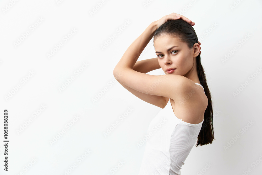 Portrait of a young woman posing with long hair against a plain white background, showcasing a minimalist aesthetic Elegant expression and natural beauty highlighted Portrait of a young woman posing with long hair against a plain white background, showcasing a minimalist aesthetic Elegant expression and natural beauty highlighted