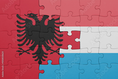 puzzle with the colourful national flag of albania and flag of luxembourg .