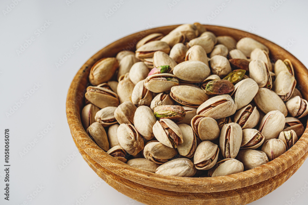 Fresh Pistachios: Nutritious Green Nuts on a White Background Fresh Pistachios: Nutritious Green Nuts on a White Background