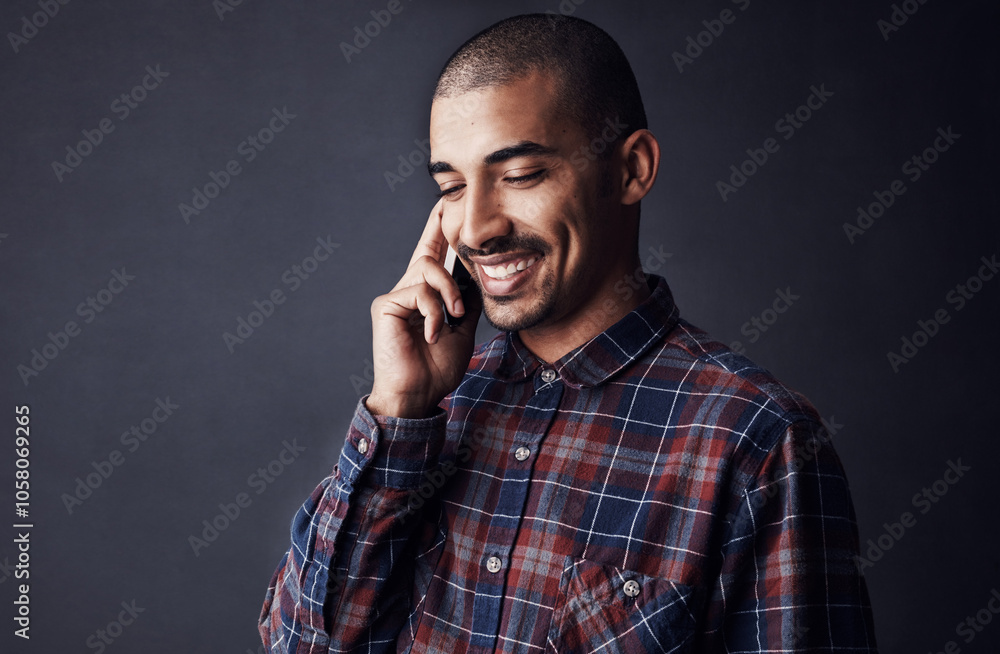 Man, smile or phone call in studio for contact, good news or feedback for creative small business. Designer, entrepreneur or happy with tech for networking with conversation on black background space Man, smile or phone call in studio for contact, good news or feedback for creative small business. Designer, entrepreneur or happy with tech for networking with conversation on black background space