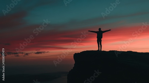 Silhouette of a Person Standing on a Cliff at Sunset with a Dramatic Sky